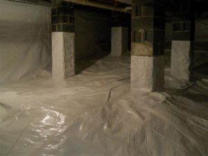 A moisture vapor barrier in a waterproofed crawlspace