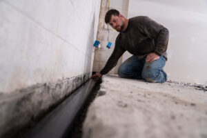 an ESOG tech completing a Basement Waterproofing project