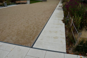 park square with gravel compacted paths and concrete sidewalk